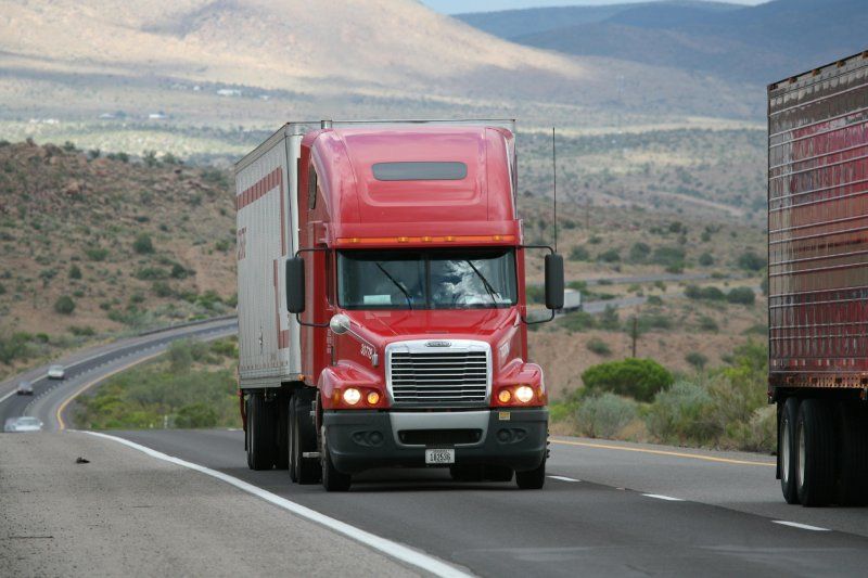 18-wheeler driving through desert.