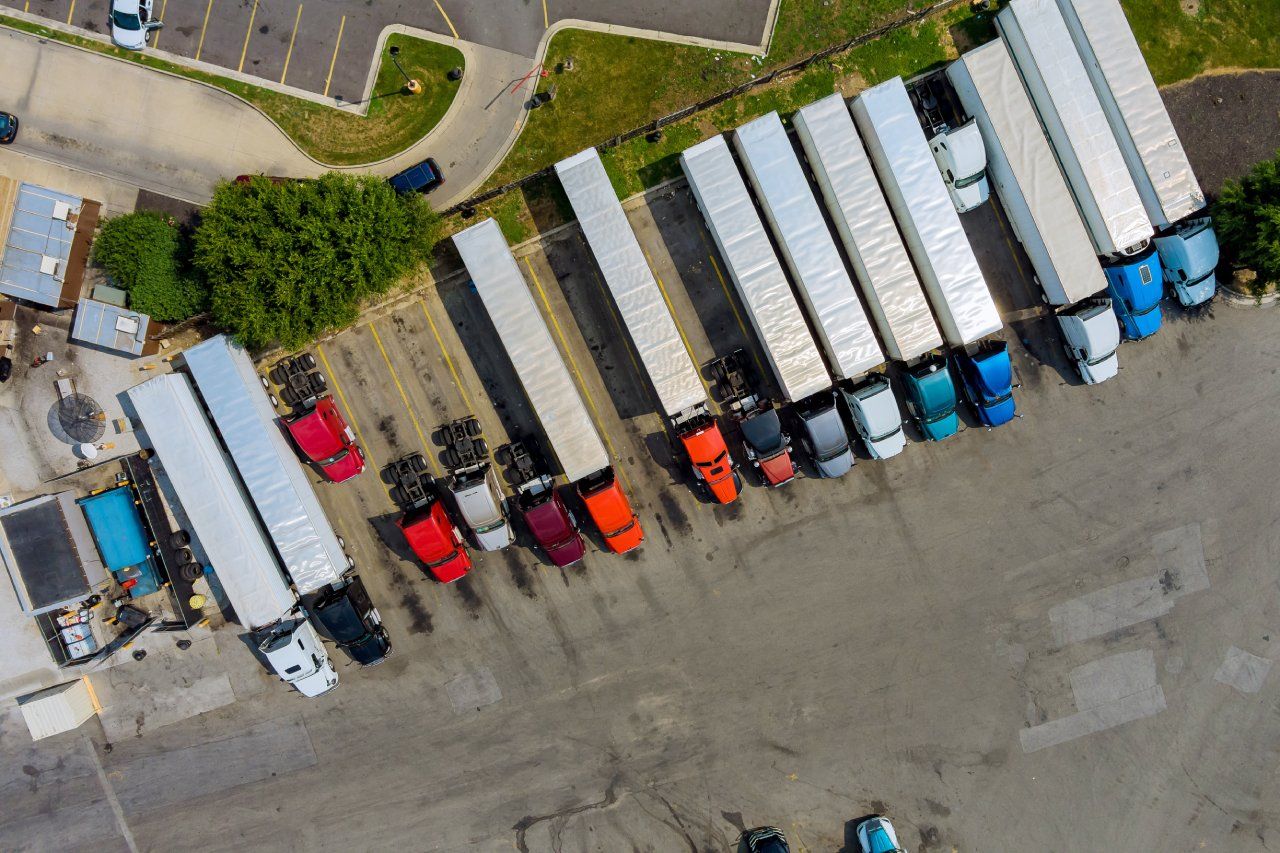Aerial view of a row of 18-wheelers parked